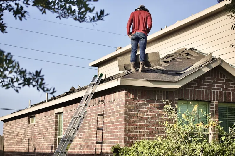 Professional roofer working on a residential roof in Fountainville